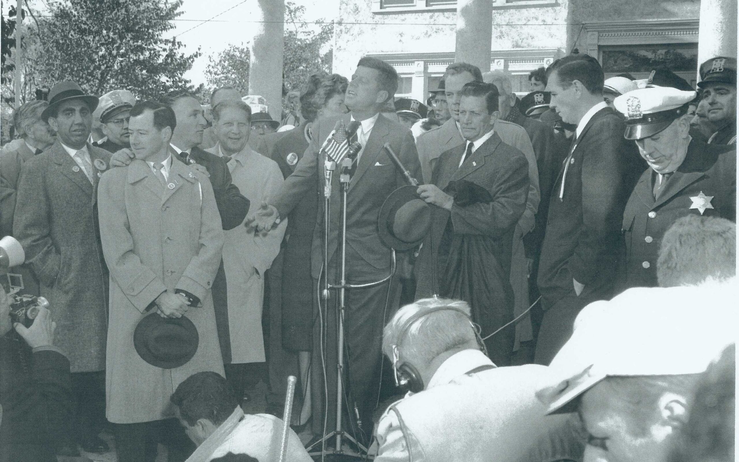 John F. Kennedy speaking in from of Cook House.