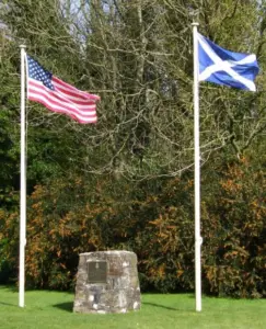 Scottish and American Flags Flying by Monument