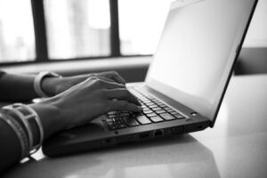 Person Typing at Laptop