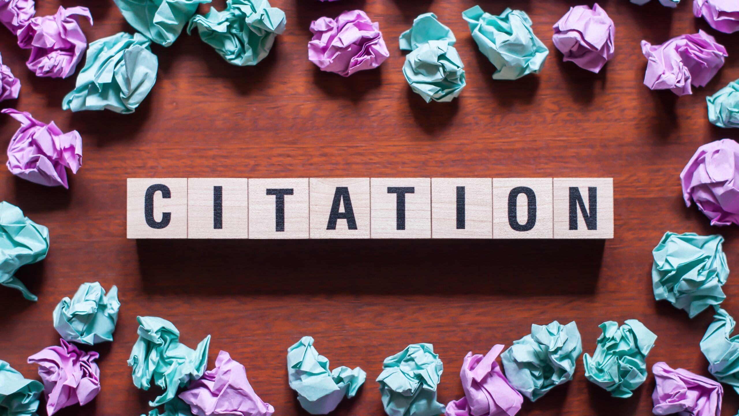 Citation Spelled Out on a Table with Crinkled Papers